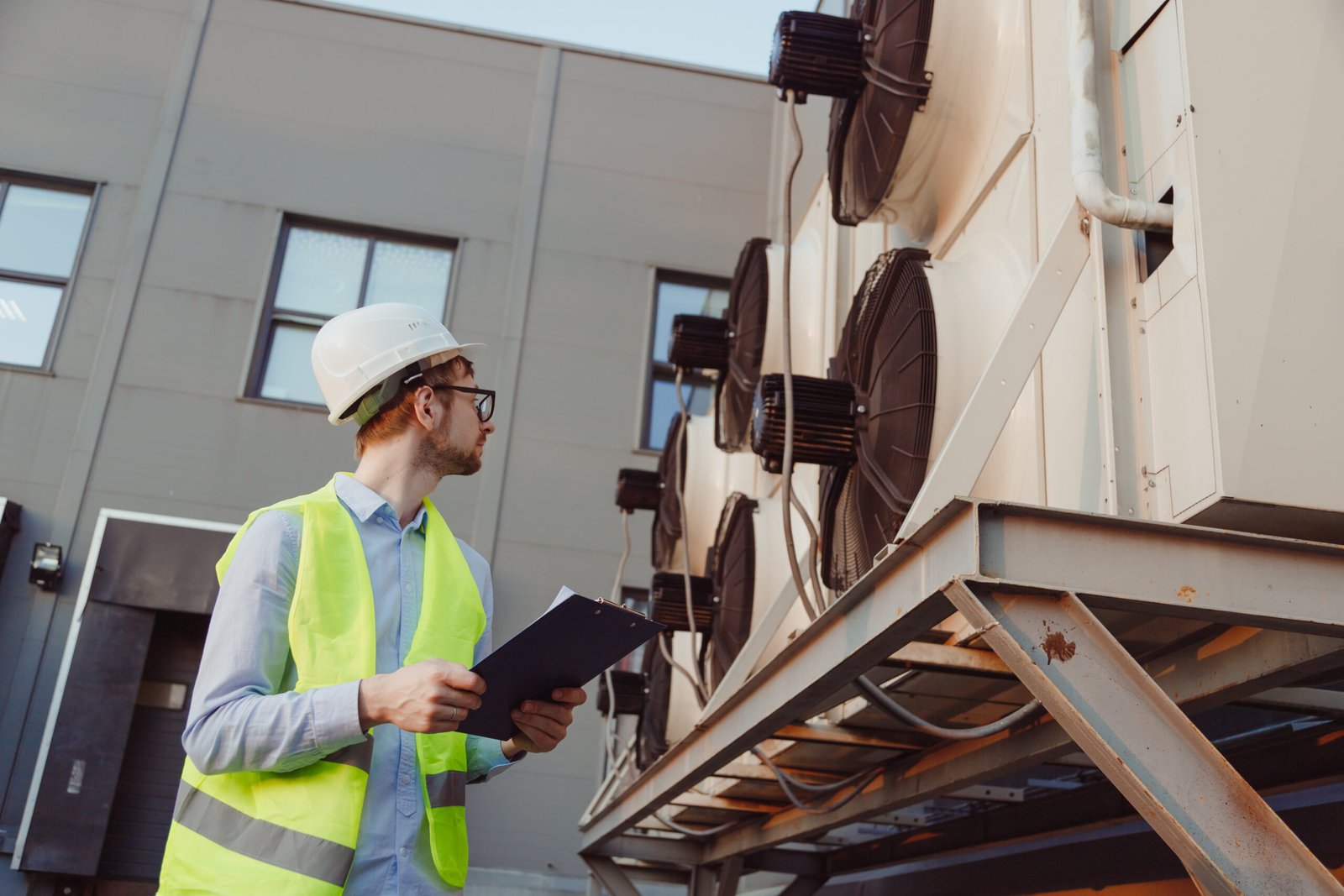 service-hvac-engineer-in-uniform-inspecting-indust-2023-11-27-05-18-36-utc-scaled.jpg